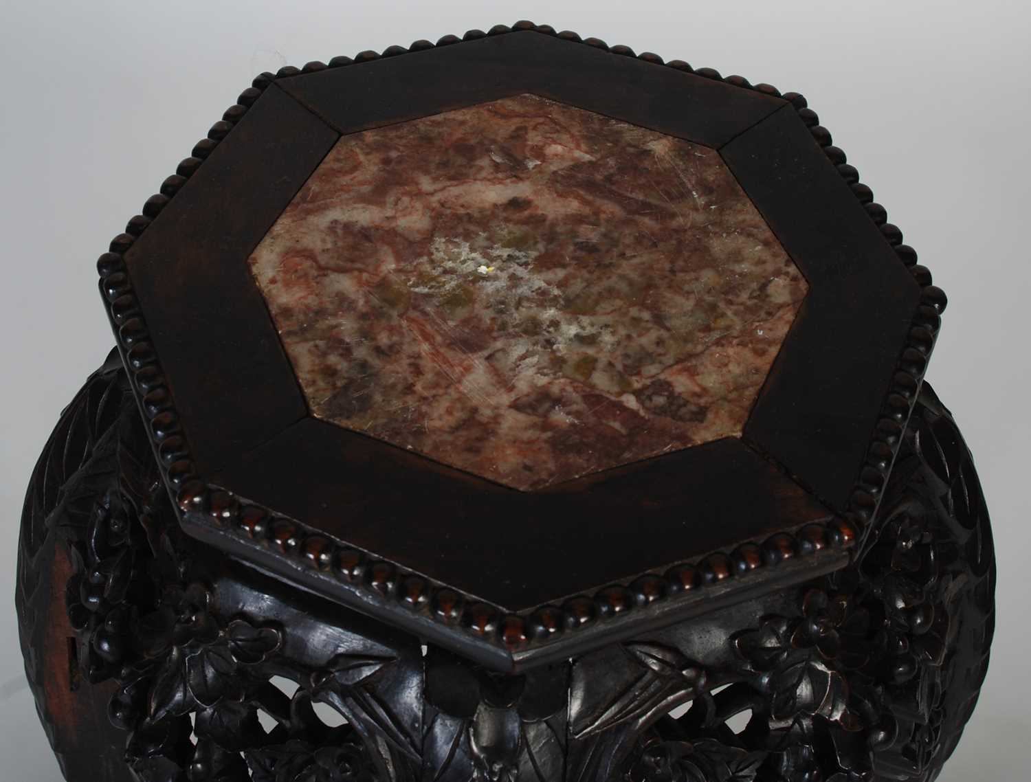 A Chinese dark wood urn stand, late 19th/ early 20th century, the octagonal-shaped top centred - Image 2 of 7