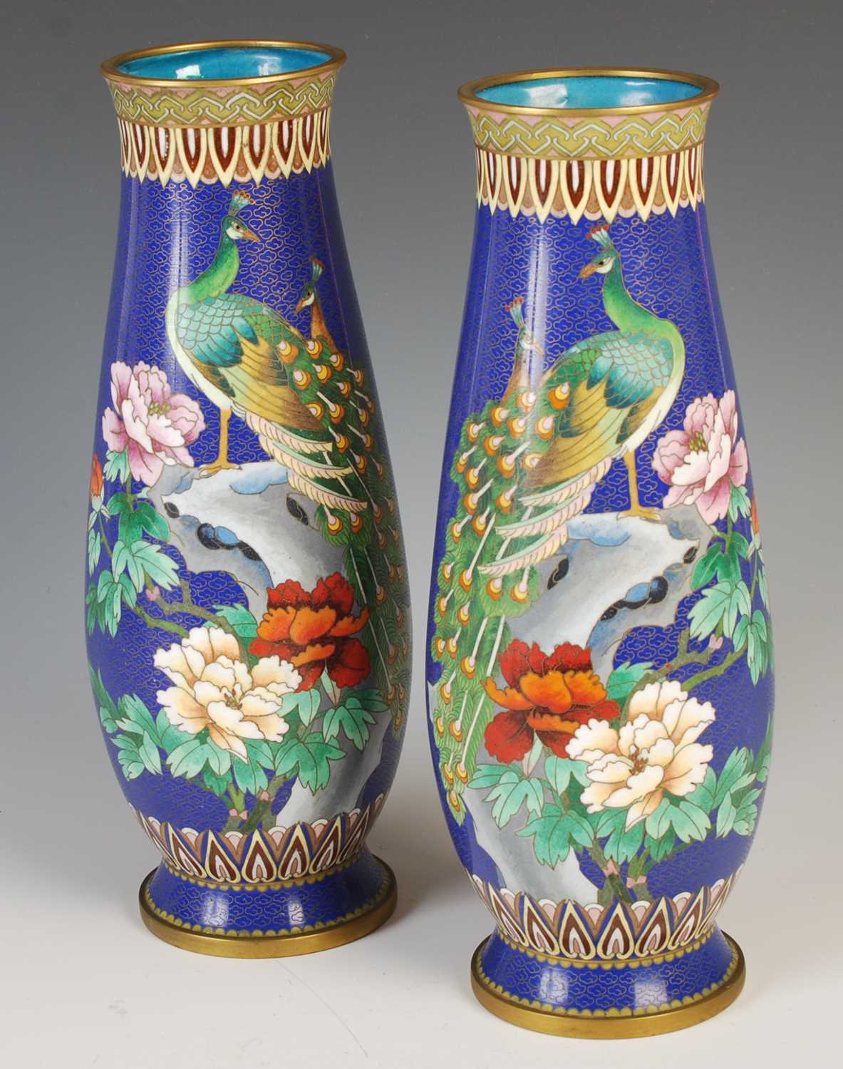 A pair of Chinese blue ground cloisonne vases, late 19th / early 20th century, decorated with a pair