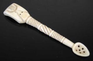 A Scottish large bone snuff spoon with finely carved wrythen-fluted and hatched stem, the spade-