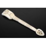 A Scottish large bone snuff spoon with finely carved wrythen-fluted and hatched stem, the spade-