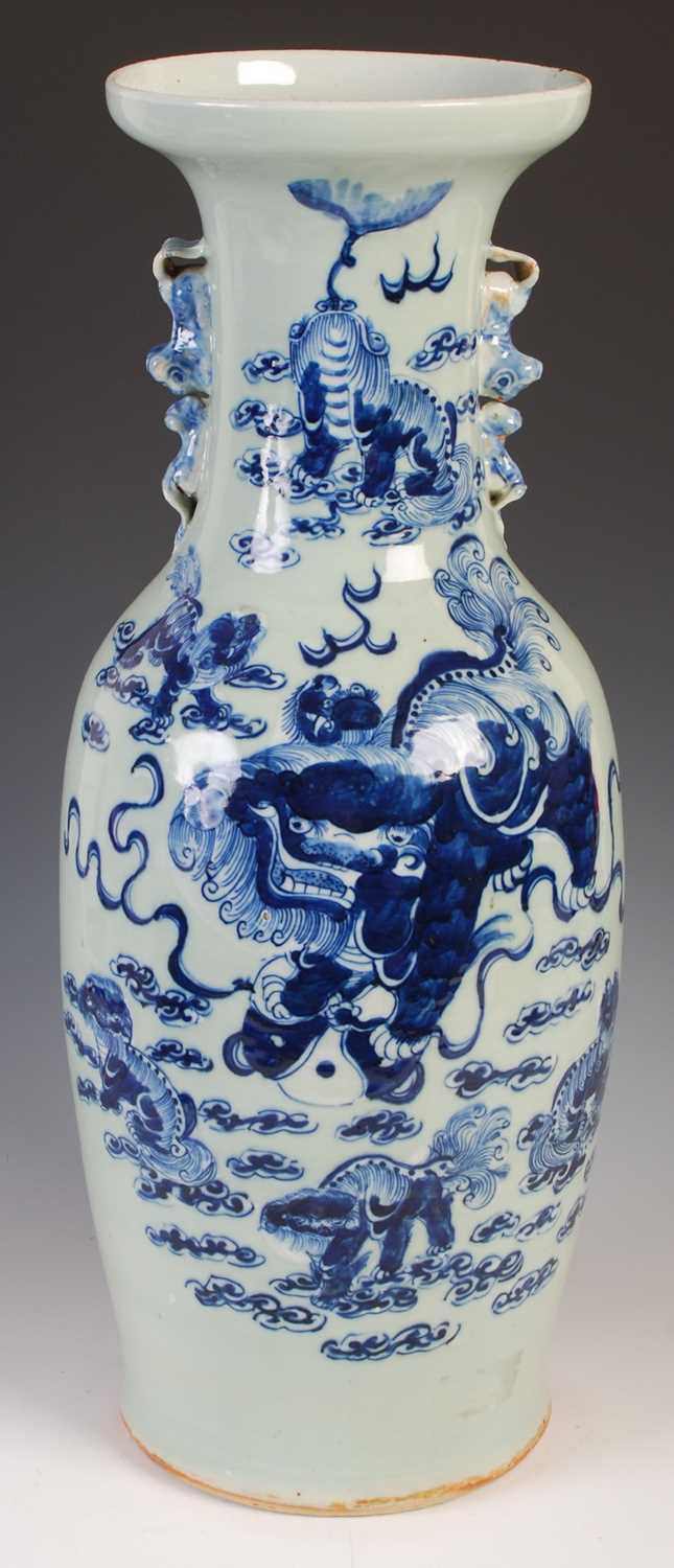 A large Chinese porcelain celadon ground vase, Qing Dynasty, decorated with shishi and five cubs,