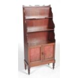 A 19th century Regency style mahogany waterfall bookcase, fitted with three graduated open shelves