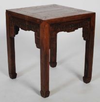A Chinese dark wood square occasional table, late Qing Dynasty, the square panelled top above a