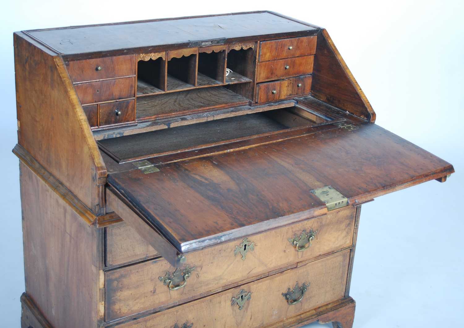 A George II walnut bureau, the rectangular fall-front opening and resting on loppers, to a fitted - Image 10 of 13