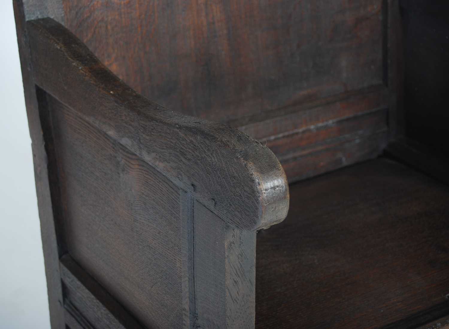 An 18th century oak lambing chair, the shaped top rail above a rectangular panelled back, the box - Image 3 of 6