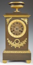 An early 19th century French bronze and gilt metal mantle clock, the circular dial with Roman