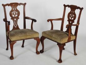 A pair of George III style mahogany elbow chairs, 20th century, the flower and scroll carved top