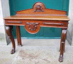 A 19th century oak console table, the upright back centred with oval cartouche, with shield shaped