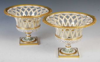 A pair of 20th century Continental porcelain pedestal bowls, each with pierced lattice work sides,