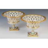 A pair of 20th century Continental porcelain pedestal bowls, each with pierced lattice work sides,