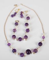 A suite of yellow metal pearl and amethyst jewellery, comprising; a necklace stamped '9K'; bracelet,