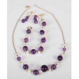 A suite of yellow metal pearl and amethyst jewellery, comprising; a necklace stamped '9K'; bracelet,