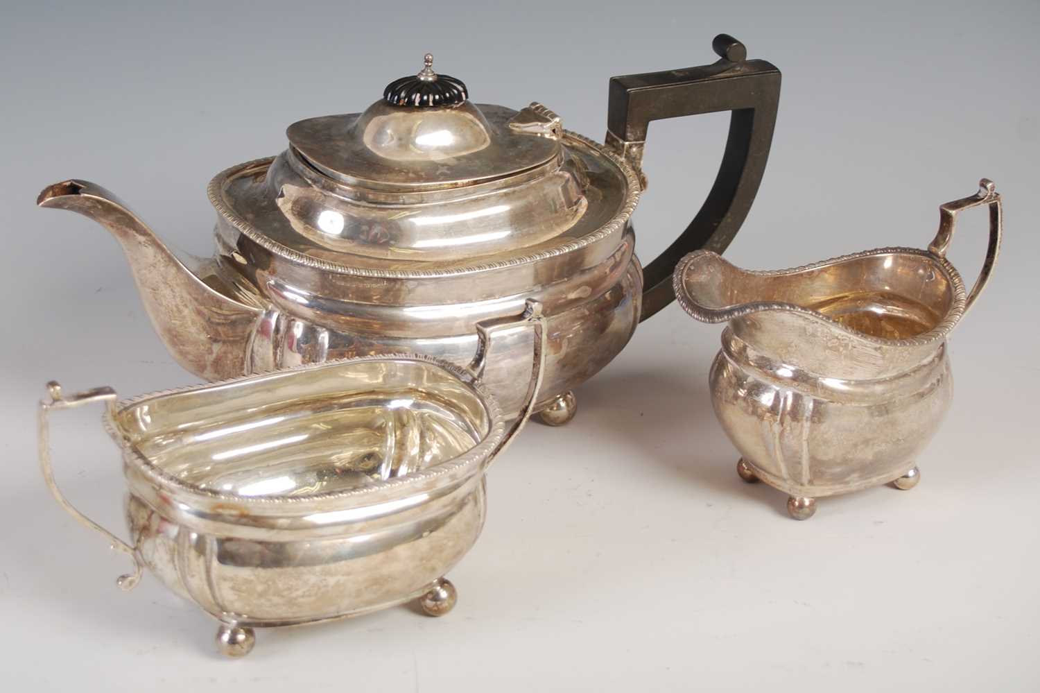 A George V silver three-piece tea set, London, 1926, makers mark of W&S, oval shaped with fluted