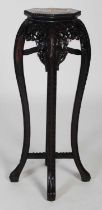 A Chinese dark wood urn stand, late 19th/ early 20th century, the octagonal-shaped top centred