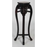 A Chinese dark wood urn stand, late 19th/ early 20th century, the octagonal-shaped top centred