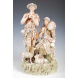 A Royal Dux porcelain figure group modelled with male and female musicians playing the pipes and