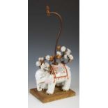 A Japanese porcelain model of an elephant, mounted as a table lamp, with scrolling gilt metal arms