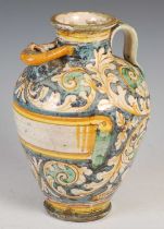 An antique Maiolica pottery flagon, decorated with scrolling foliage with vacant scroll banner, 26cm