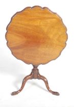A George III mahogany snap-top occasional table, the shaped circular top with an egg and dart carved