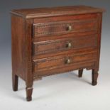 A late 18th / early 19th century French oak apprentice-made commode, the rectangular top with