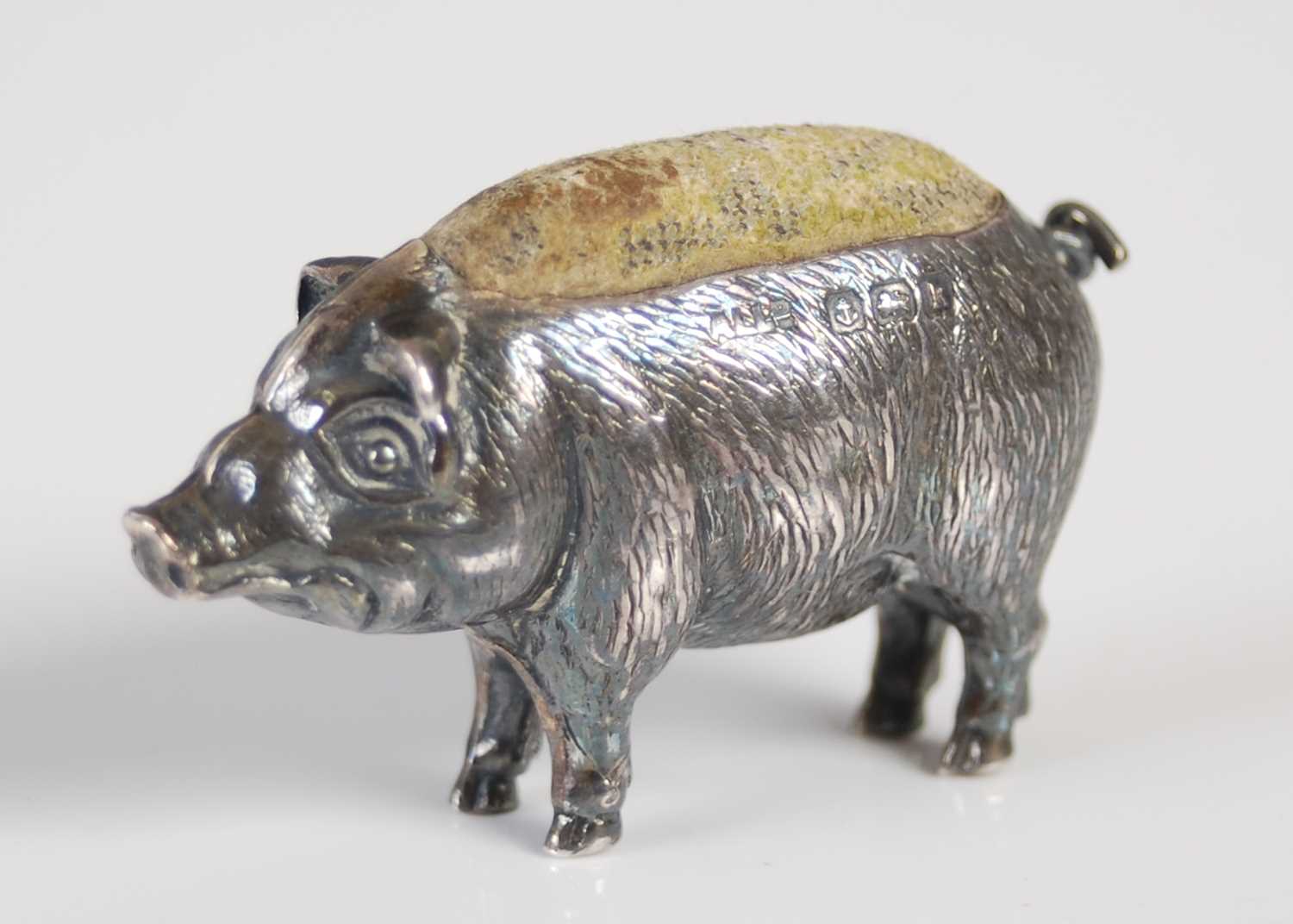 An Edwardian silver pin cushion modelled as a pig, Birmingham 1909, makers mark for 'Adie &