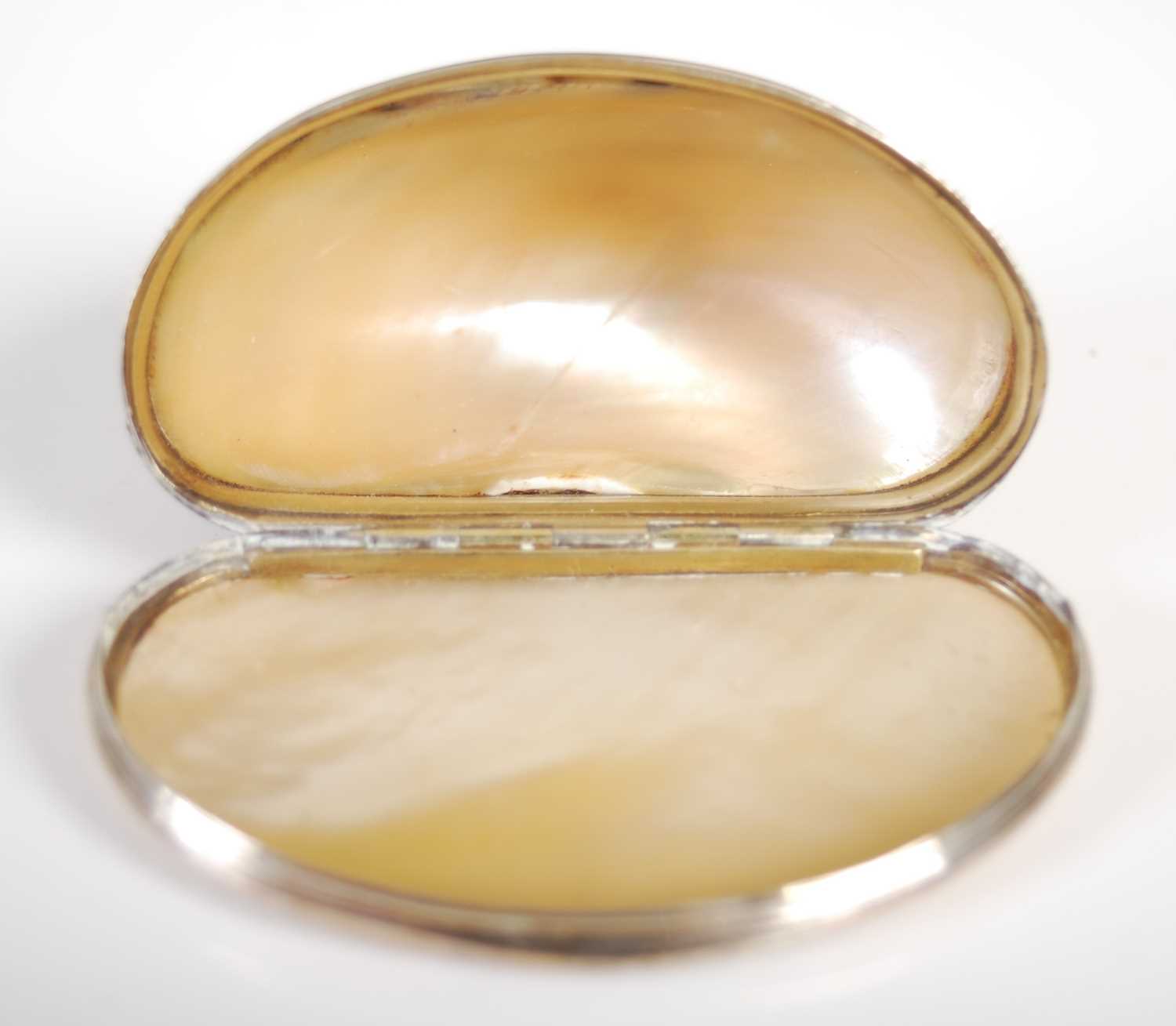 A Cittarium Pica ‘magpie’ shell snuff box, carved to produce a decorative design, with reeded silver - Image 3 of 3