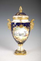 A Coalport hand-painted blue ground urn and cover, decorated with a view of Balmoral Castle,