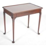 A George II red walnut silver table, the dished rounded rectangular top above a blind frieze