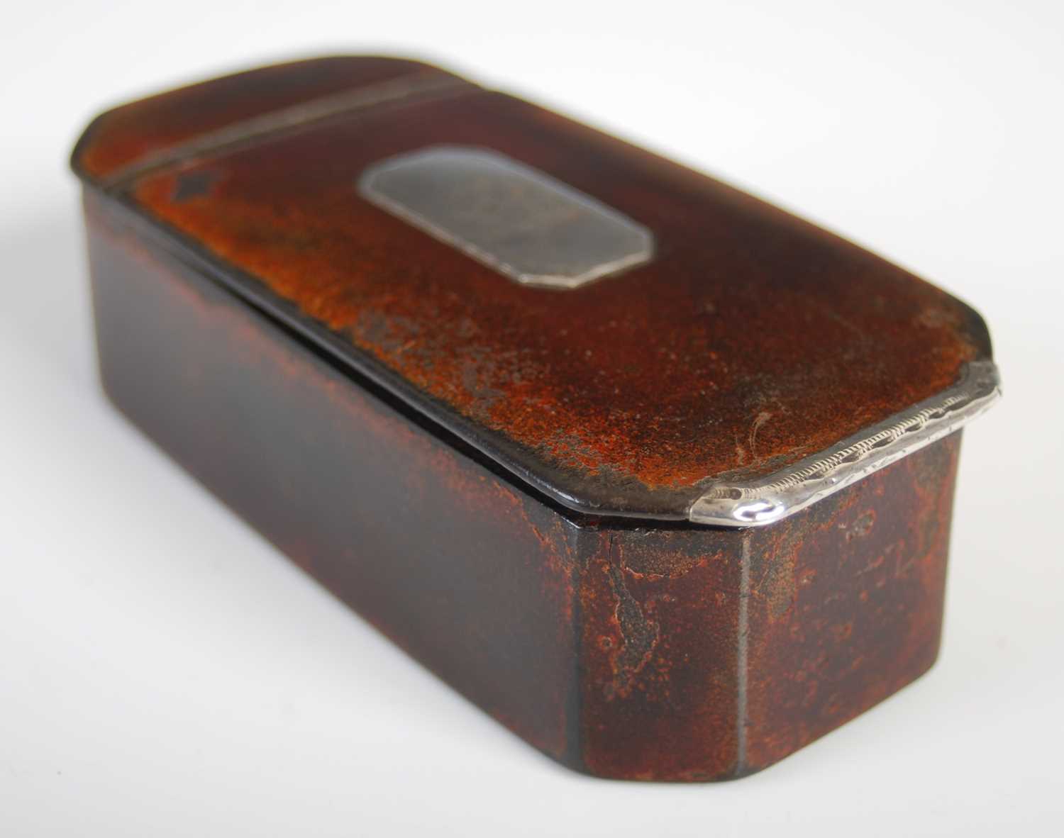 A Scottish leather cut-cornered oblong snuff box with integral leather hinge, silver plaque engraved