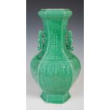 A Chinese porcelain hexagonal shaped twin handled archaic style monochrome green glazed vase, Qing