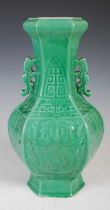 A Chinese porcelain hexagonal shaped twin handled archaic style monochrome green glazed vase, Qing