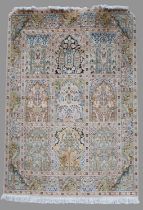 An Indian silk rug, 20th century, the rectangular ground decorated with nine mihrab shaped panels