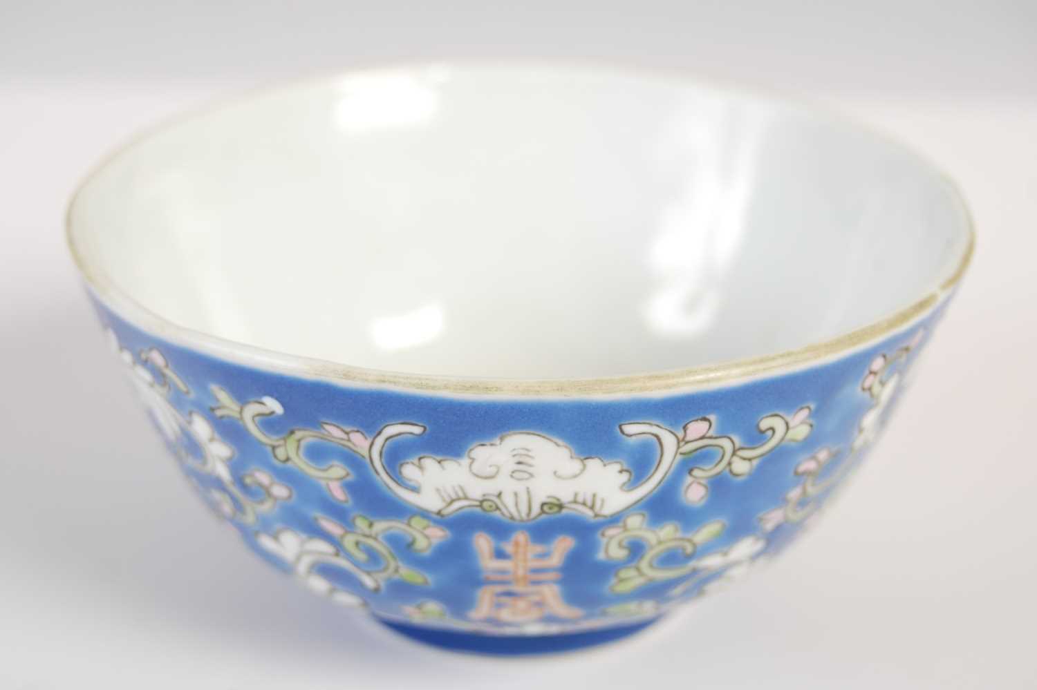 A Chinese porcelain blue ground footed bowl, late 19th/ early 20th century, decorated with lotus