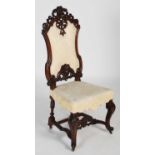 A 19th century carved walnut hall chair, the upright back with foliate and scroll carved surmount