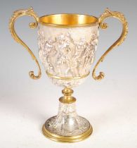 A Victorian silver-plated and gilt metal twin-handled cup, decorated in high relief with a frieze of