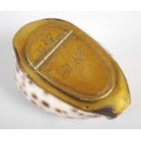 A large cowrie shell snuff box with brass mounts, the hinged cover engraved with a water jug and