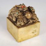 A Chinese gilt metal seal, early 20th century, modelled with three dragons and a flaming pearl,