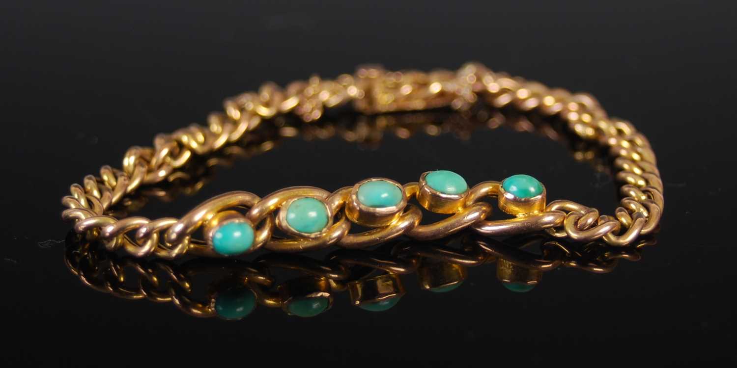 A yellow metal and turquoise bracelet, set with a row of five cabochon cut turquoise, stamped '