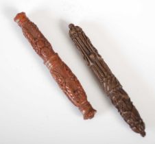 Two 19th century carved coquilla nut two-part needle cases, one carved with stylised flowers and