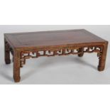 A Chinese dark wood Kang table, late 19th/ early 20th century, the rectangular panel top above a
