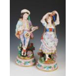 A pair of late 19th century French Bisque porcelain figures, modelled as a boy playing the