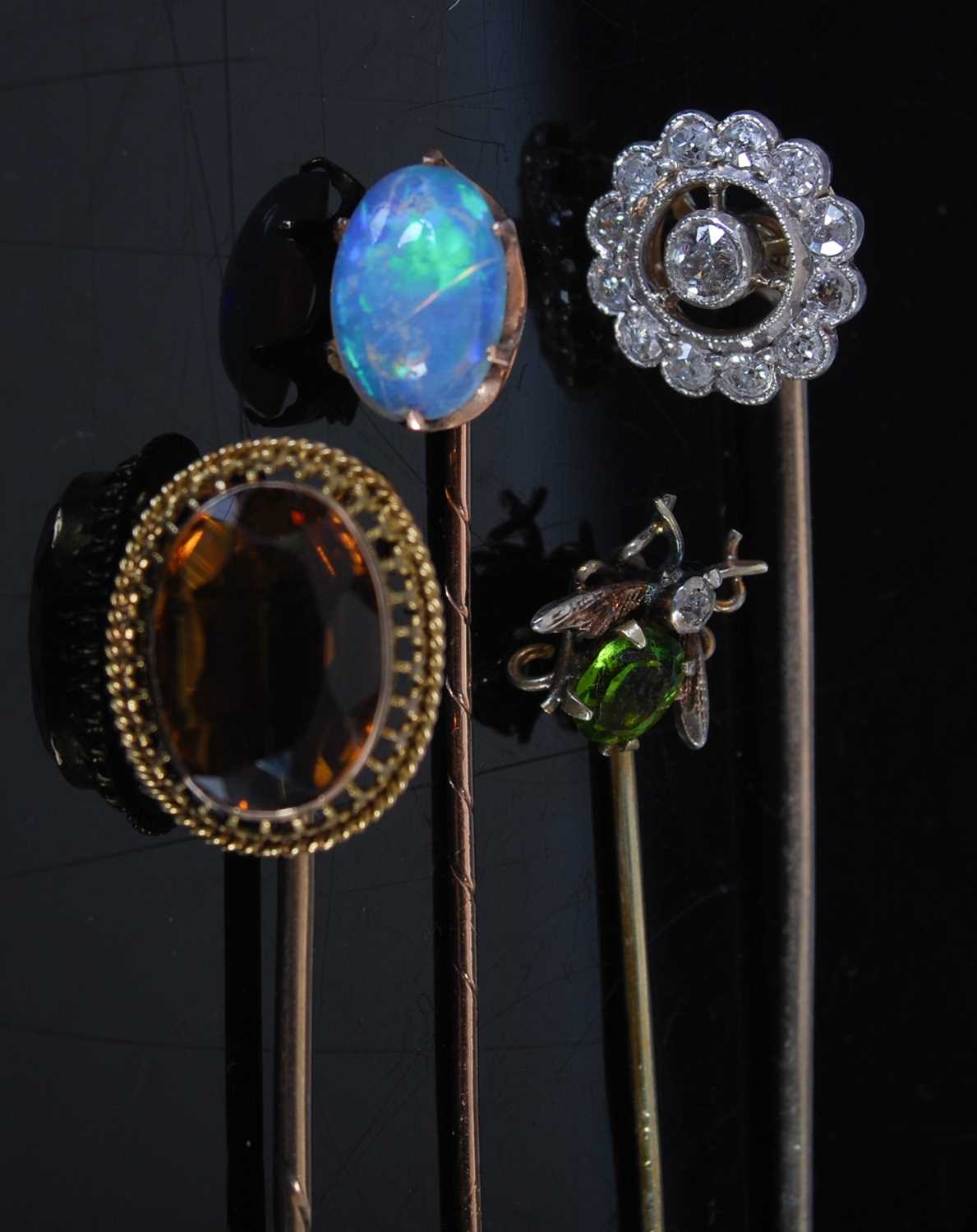 A collection of four late 19th century and later stick pins, comprising; a yellow metal diamond - Image 2 of 3