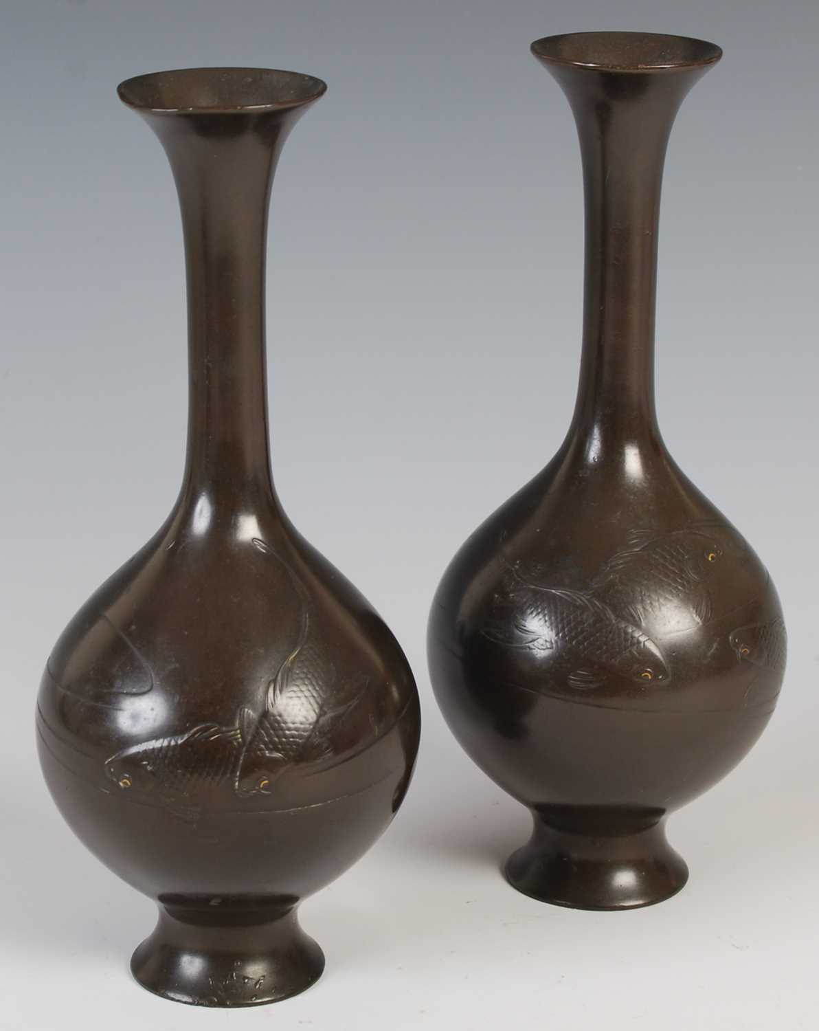 A pair of Japanese bronze bottle vases, late 19th / early 20th century, decorated in shallow