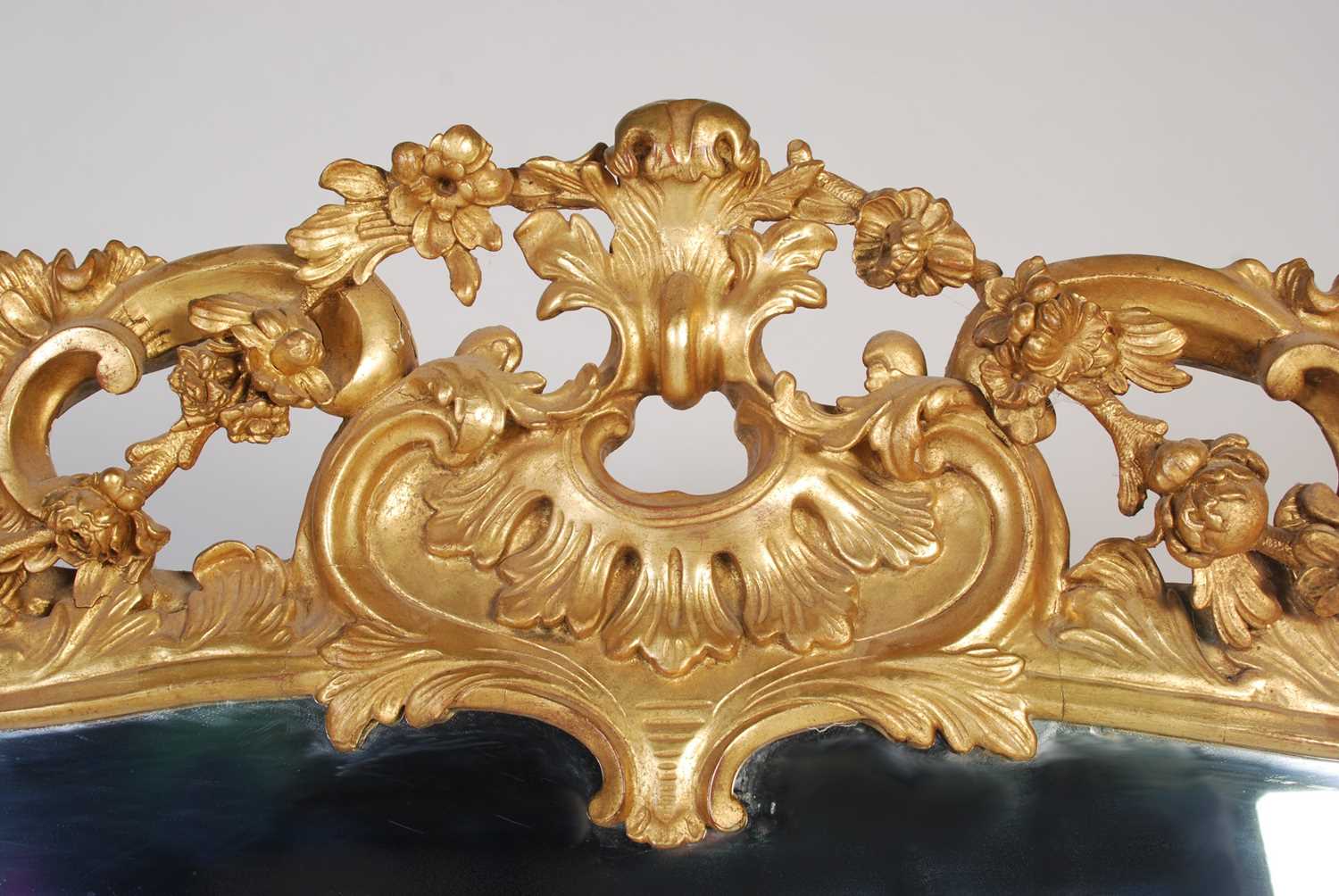 A 19th century carved giltwood over mantel mirror, the frame carved with scrolls, flowers and - Image 3 of 5