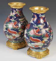 A pair of Chinese blue ground cloisonne pear-shaped vases, late Qing Dynasty, each decorated with