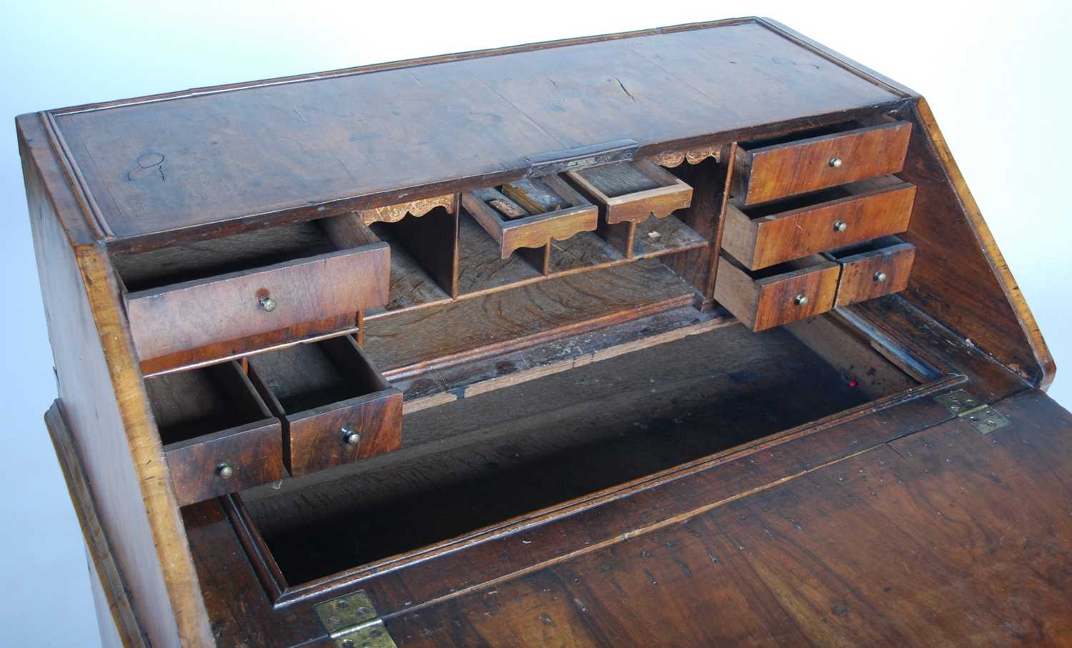 A George II walnut bureau, the rectangular fall-front opening and resting on loppers, to a fitted - Image 11 of 13