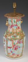 A Chinese porcelain famille rose canton vase converted to a table lamp, Qing Dynasty, decorated with