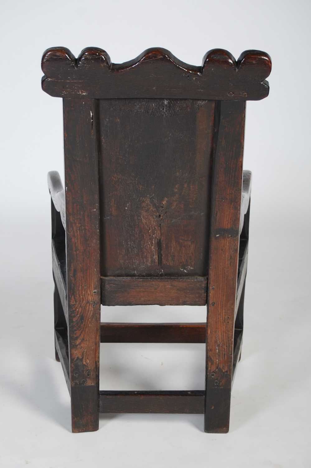 An 18th century oak wainscot elbow chair, the shaped top rail carved with two demi-lune stylised - Image 7 of 7