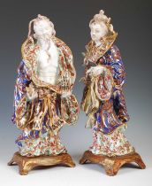 A pair of decorative ceramic figure groups, 20th century, modelled as male holding teapot in his