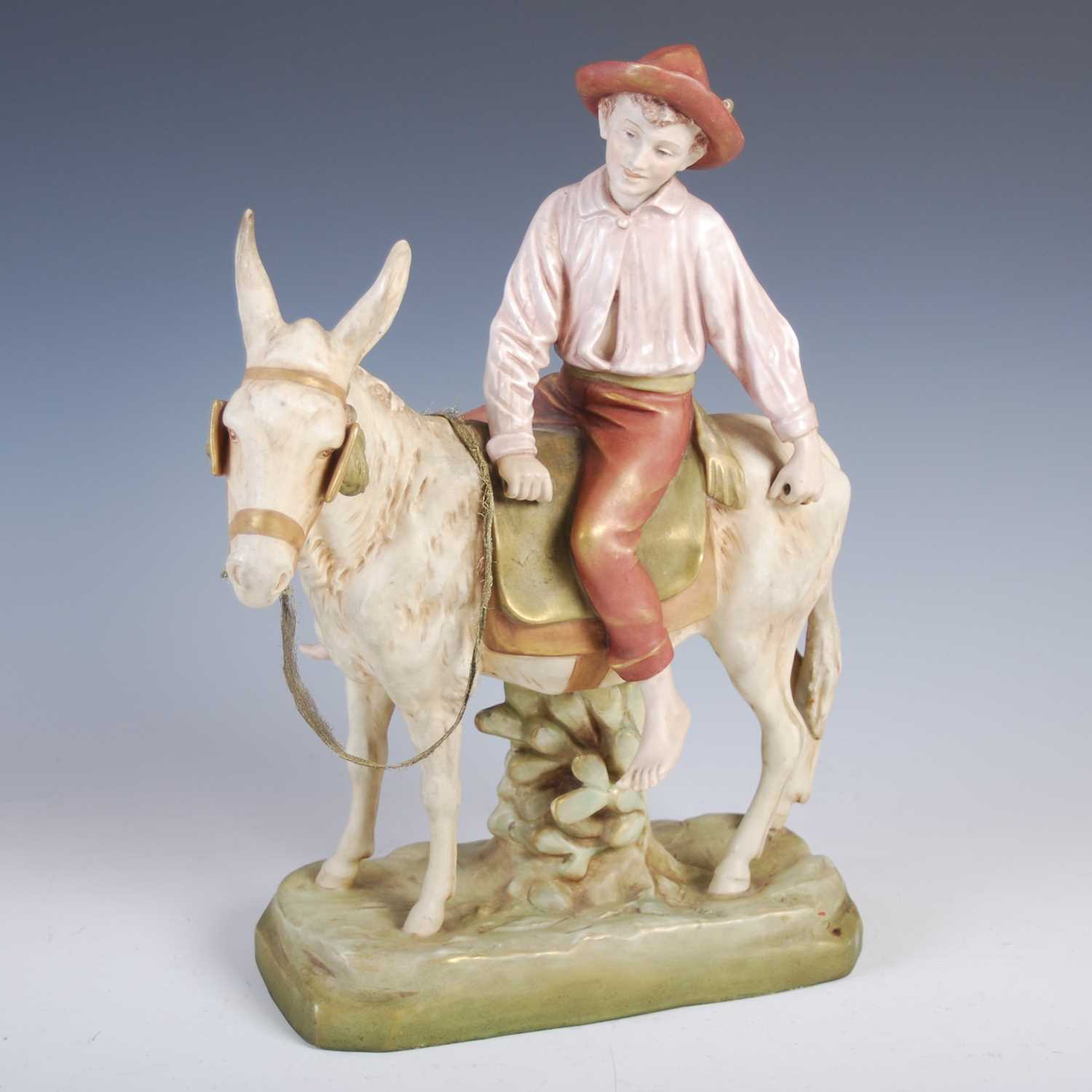 A Royal Dux porcelain figure of a boy riding a donkey, impressed marks, no.1989, 376cm high.